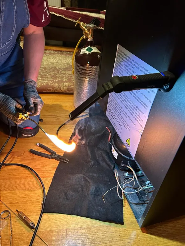 Appliance repair technician at work